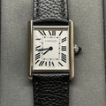 Square Cartier wristwatch with silver case, black leather strap, white dial and Roman numerals.