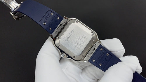Cartier watch backplate in silver tone on blue strap, clasp visible