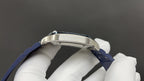 Cartier watch top view with silver bezel and blue leather strap