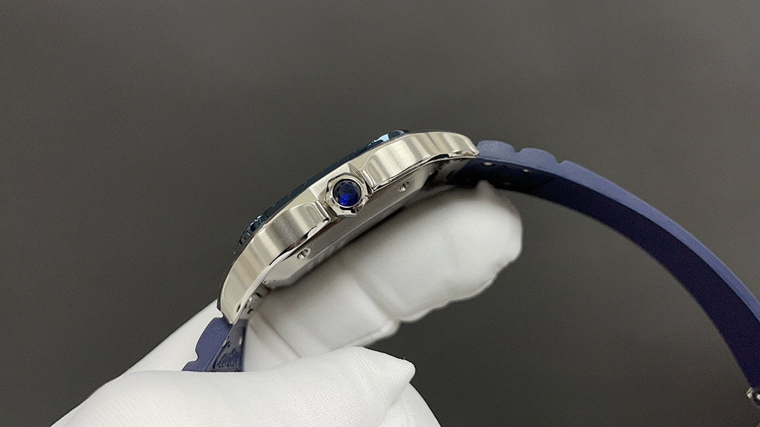 Cartier watch side view with blue strap and silver case, blue crown gem