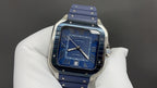 Cartier watch front view with blue dial, roman numerals, and blue strap