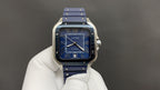 Cartier watch front view with blue dial and blue leather strap, silver case