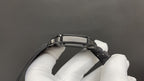 Cartier steel wristwatch case and black strap clasp, top view