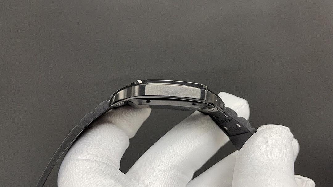 Cartier steel wristwatch case and black strap clasp, top view