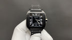 Cartier black dial wristwatch with Roman numerals, steel bracelet and crown side
