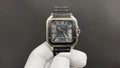Cartier stainless-steel wristwatch with black dial and black leather strap.