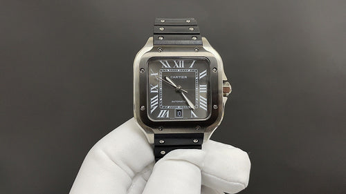 Cartier stainless-steel wristwatch with black dial and black leather strap.