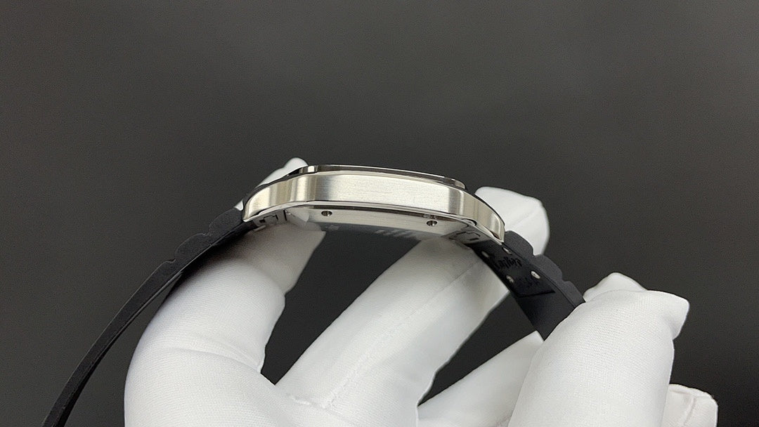 Cartier wristwatch side view with silver case and black leather strap.