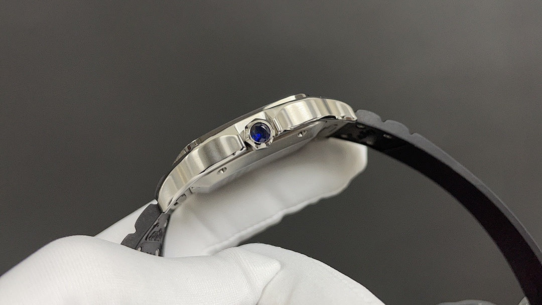 Cartier wristwatch top view with silver case and blue crown detail on black strap.