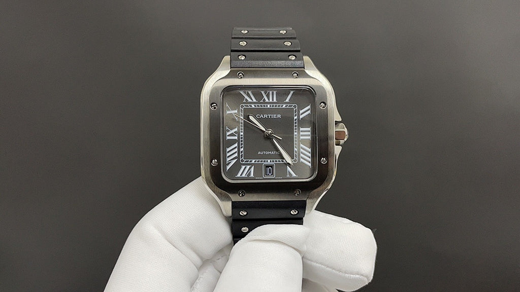 Cartier wristwatch with Roman-numeral black dial, silver case, and black leather strap.