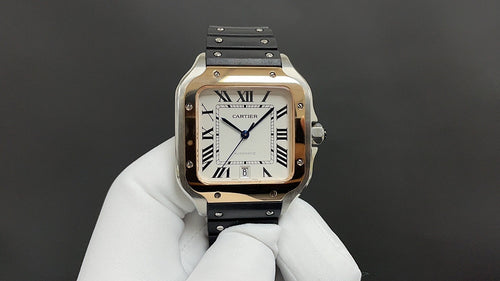 Cartier watch with gold-tone case, black strap, Roman numerals and blue hands