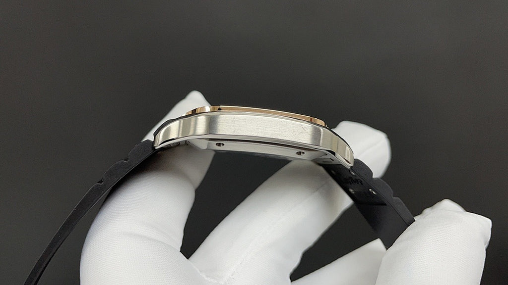 Cartier watch bezel and black strap close-up held in white-gloved hand