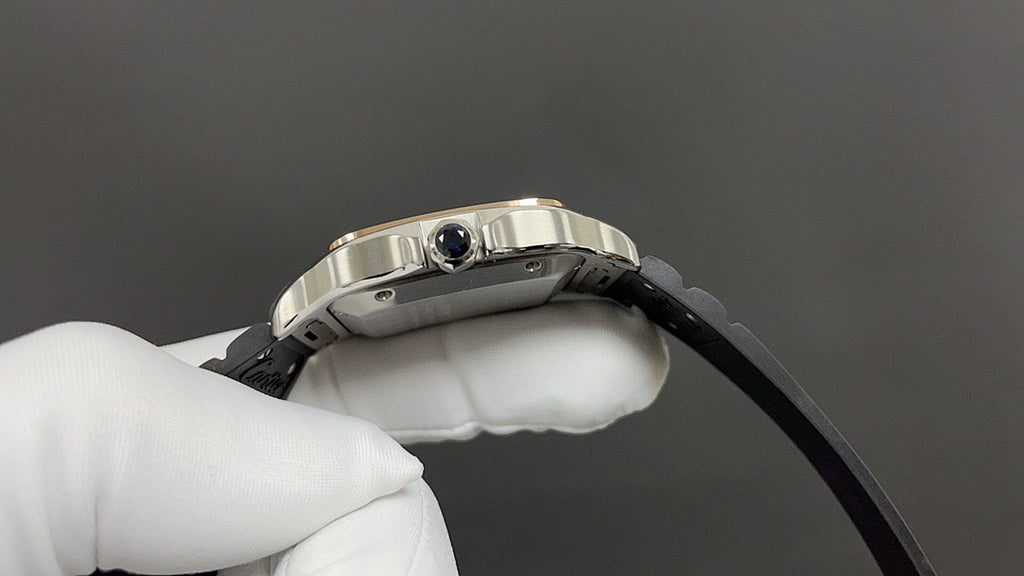 Cartier watch crown and blue lens on metal bezel, black strap