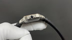 Cartier watch crown and blue lens on metal bezel, black strap