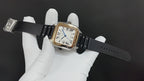 Cartier watch on black leather strap, square face with Roman numeral dial