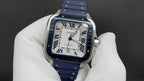 Cartier watch front view with blue dial, Roman numerals, and blue leather strap