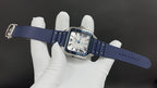 Cartier watch with blue leather strap and rectangular case, shown on wrist