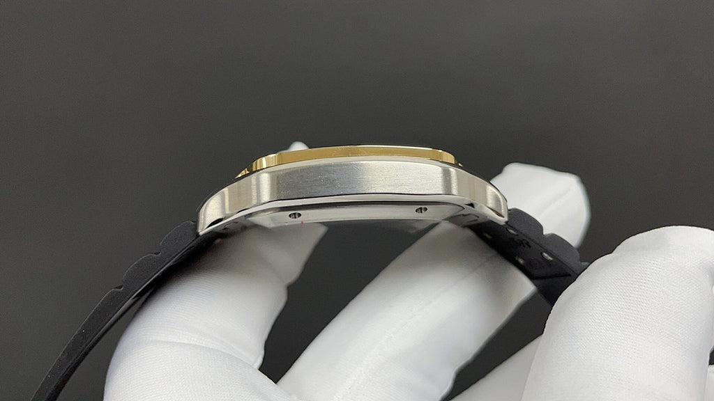 Gold-tone and silver-toned watch case with black leather strap, side profile