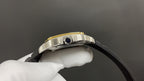 Metal watch case with crown detail and black leather strap