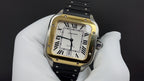 Gold-tone square wristwatch with black leather strap and Roman numeral dial