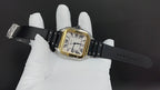 Gold-tone square wristwatch with black leather strap, Roman numeral dial and buckle