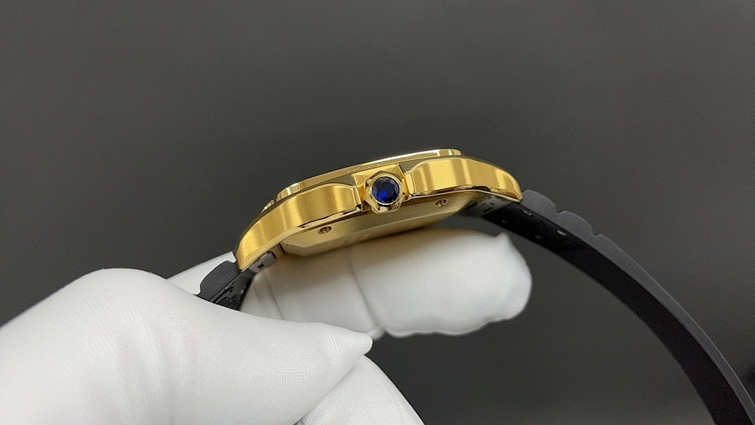 Gold Cartier watch side view with crown and blue gem, black strap attached