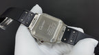 Cartier wristwatch caseback with silver back and black rubber strap, engraved markings
