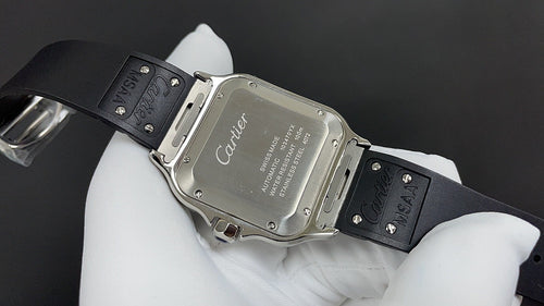 Cartier wristwatch caseback with silver back and black rubber strap, engraved markings