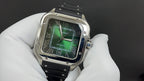 Cartier wristwatch front view with green dial, Roman numerals, silver case, black strap