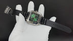 Cartier wristwatch on black rubber strap, square silver case with green dial