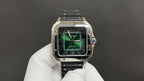 Cartier wristwatch front close-up, green dial with minute track, black rubber strap