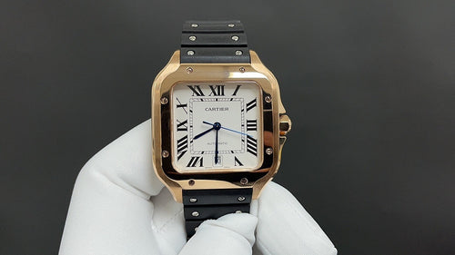 Cartier watch with gold-toned case, black strap, white roman numeral dial