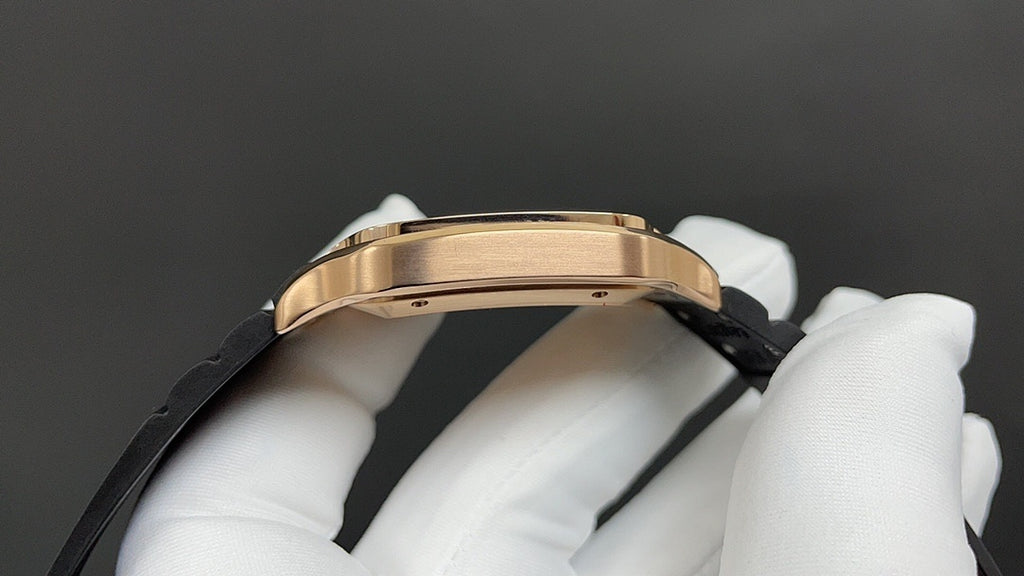 Cartier watch side view with gold-toned case and black strap held in white gloves