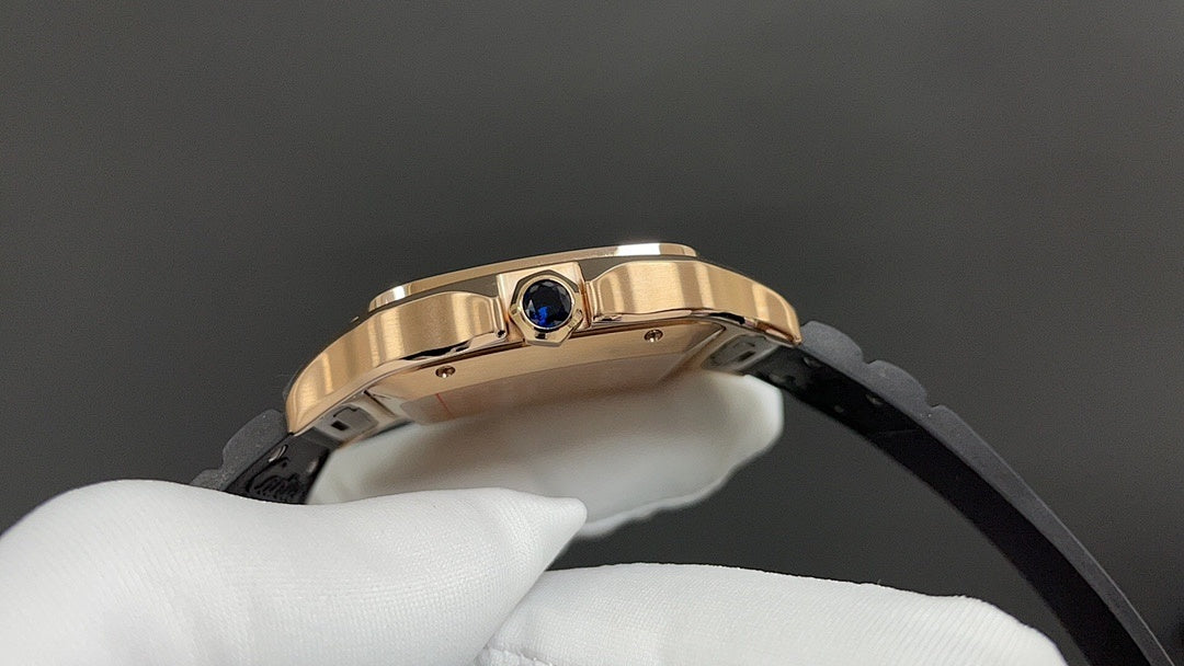 Cartier watch with blue crown detail on gold-toned bezel and black strap