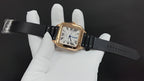 Cartier watch with black strap extended, held in white gloves