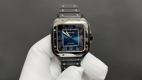 Cartier Santos watch with blue dial and black strap, held in white gloves.