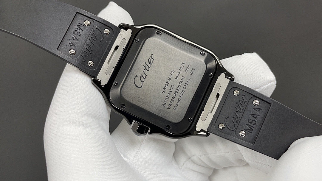 Cartier watch case with clasp and engraved back, black strap on white gloves.