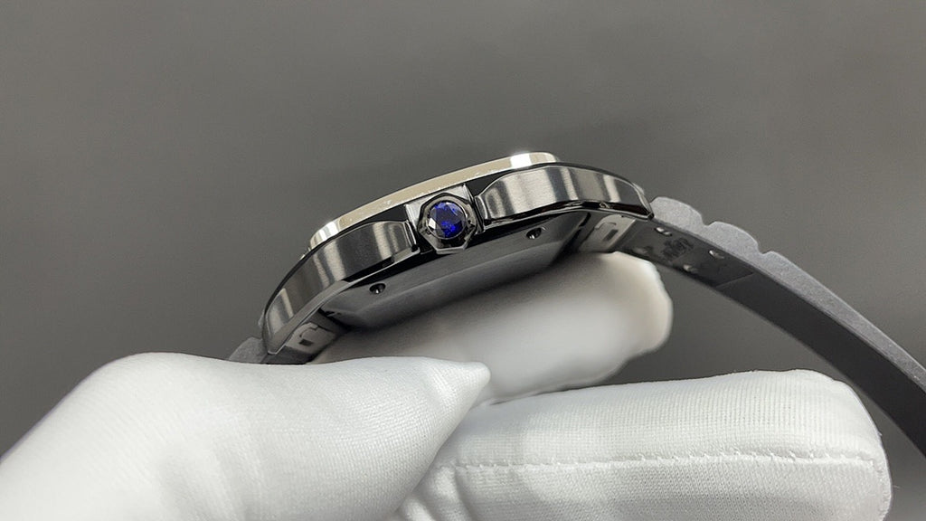 Cartier watch with stainless case and blue gem on bezel, on white gloves.