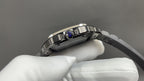 Cartier watch with stainless case and blue gem on bezel, on white gloves.