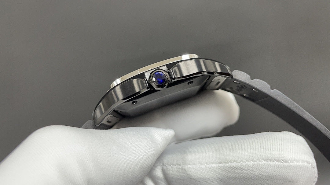 Cartier watch with stainless case and blue gem on bezel, on white gloves.