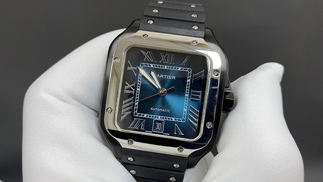Cartier Santos watch with blue dial, Roman numerals, and metal bezel on strap.
