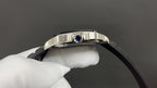 Cartier watch close-up with crown detail, silver case, and black leather strap