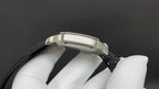 Cartier watch side profile with silver case edge and black leather strap.