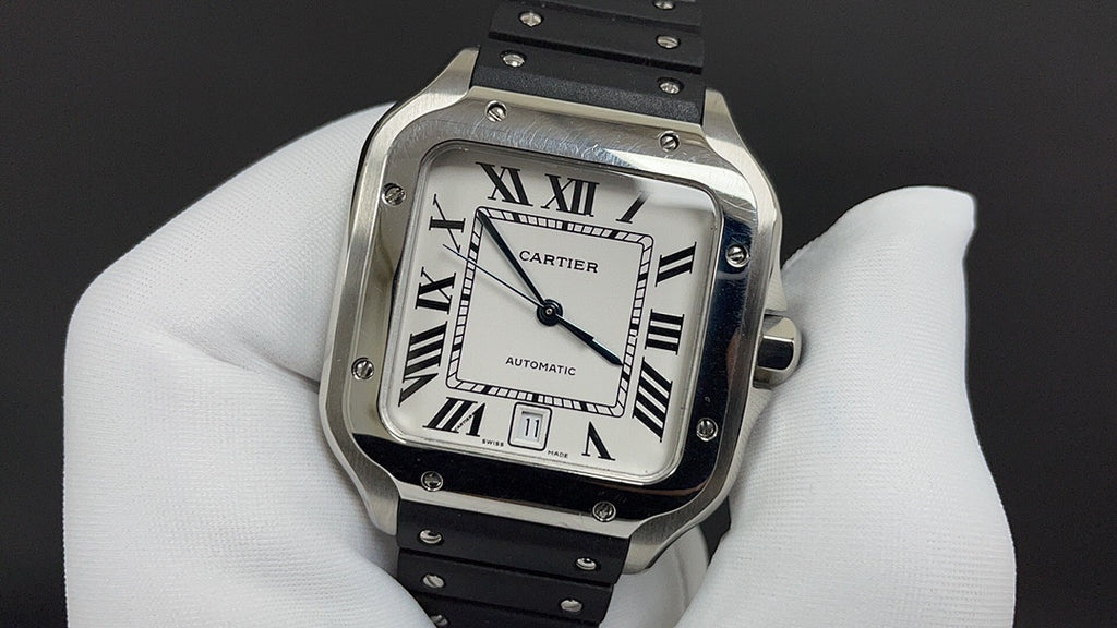 Cartier watch with silver frame, Roman numeral dial, and black leather strap detail.