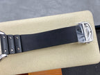 Cartier watch with black rubber strap and silver buckle clasp at the end
