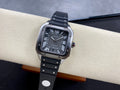 Cartier watch on black strap with Roman numeral black dial and silver case