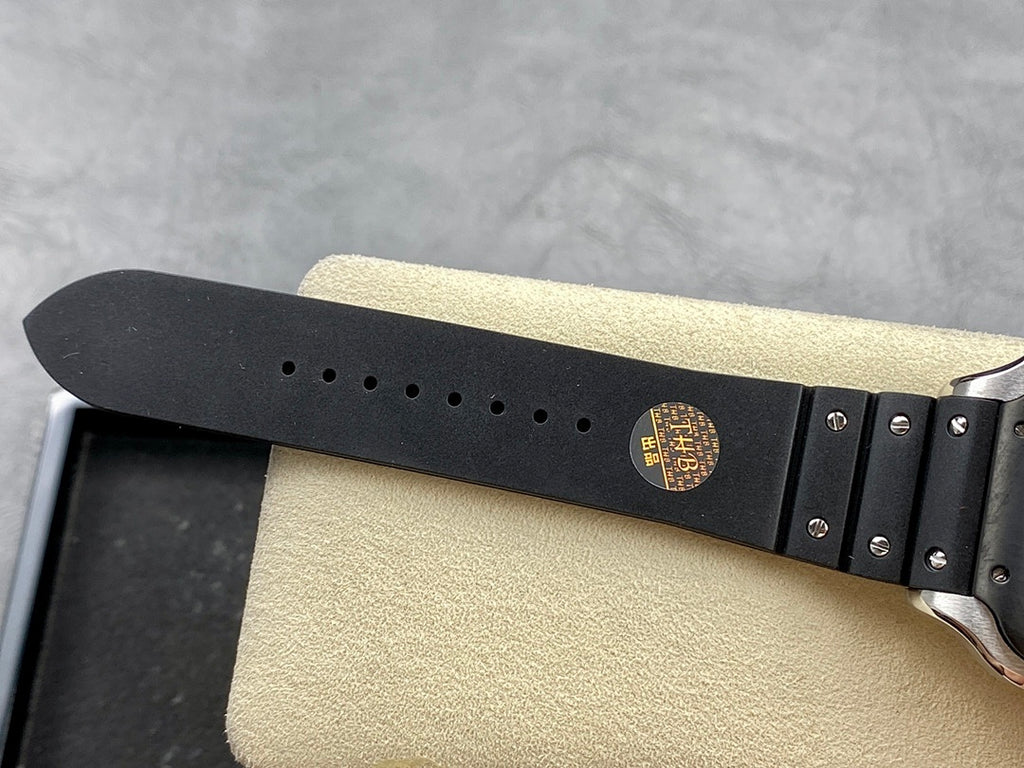 Cartier wristwatch black strap with multiple adjustment holes and gold-toned emblem on the buckle area.