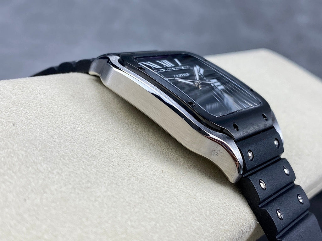 Cartier wristwatch side view with steel case edge and black bracelet links on a tan support.