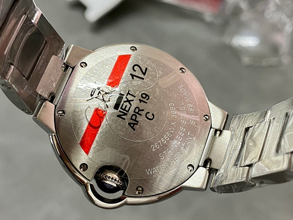 Cartier watch caseback in silver with red detail and engraved date APR 17 C