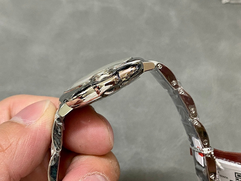 Cartier watch side profile with silver metal case and polished bezel